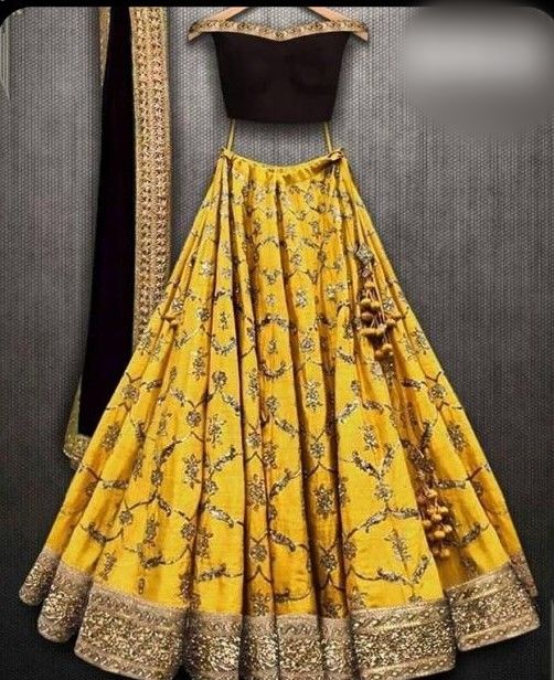Black silk off-shoulder blouse with mustard embroidered lehenga